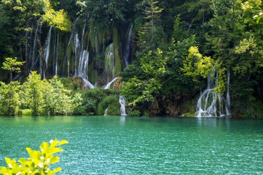 Small waterfalls in Plitvice with Lake and Trees in summer.