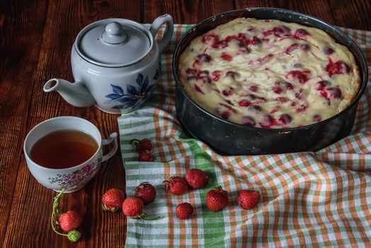 Breakfast with homemade strawberry pie, black tea and berries