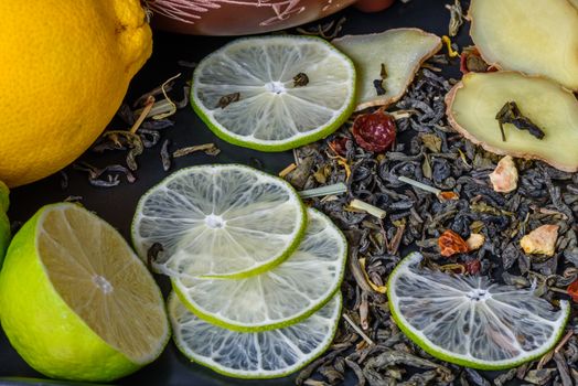 Background ingredients of recipe for a tea beverage with lime and ginger helpful for colds.