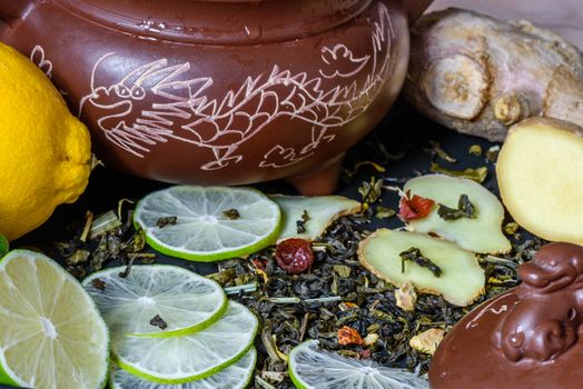 recipe for a tea beverage with lime and ginger helpful for colds. Asian teapot with dragon
