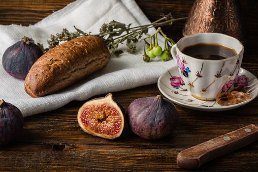 Light breakfast with coffee, multigrain bun and few ripe figs.
