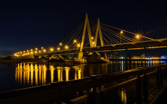 Night cityscape of the bridge across the river in Kazan. one of the places for walking and tourism