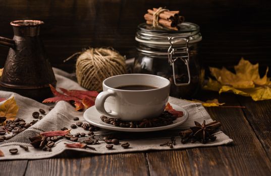 Cup of coffee at autumn evening. Some ingredients, spices and some kitchenware