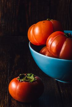 Still Life with Autumn Fruits Persimmons in Blue Bowl, Vertical.