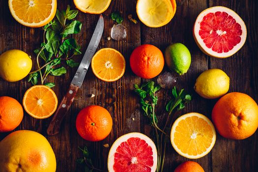Background with Sliced Citrus Fruits, Mint and Knife. Top View.