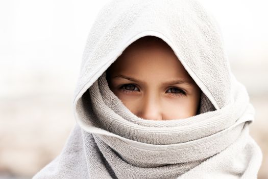 Little child boy wearing arabian burka or hijab islam religion style clothing