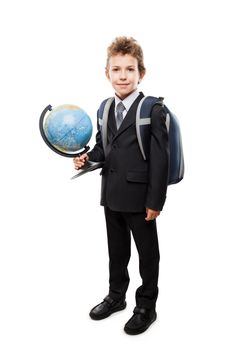 Handsome smiling child boy pupil in business suit hand holding planet Earth globe and school backpack white isolated