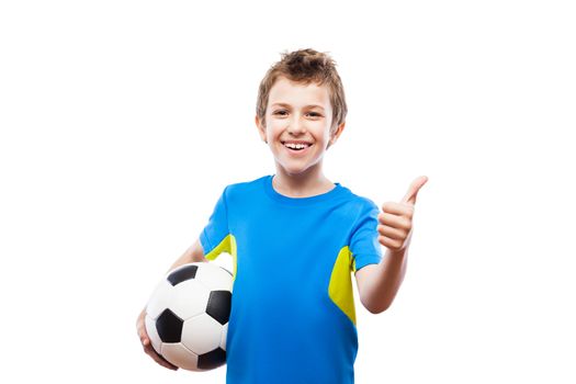 Handsome smiling child boy hand holding soccer ball gesturing thumb up success sign white isolated