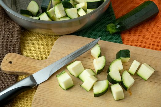 Healthy chopped zucchini on a cutting board with knife