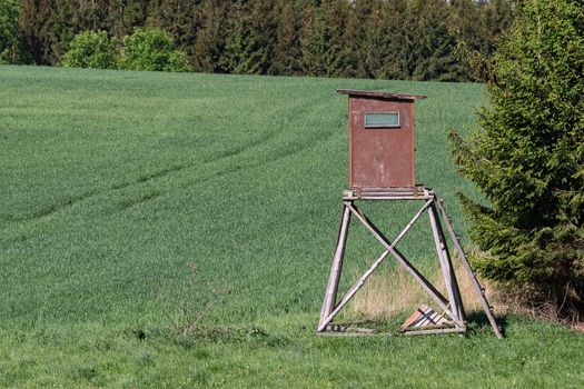 Wooden lookout tower for hunting in the woods and on meadow