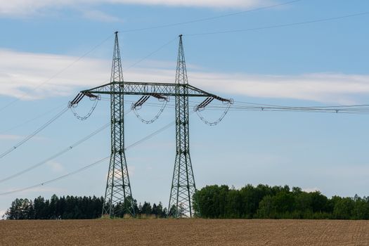 High voltage power lines with blue sky