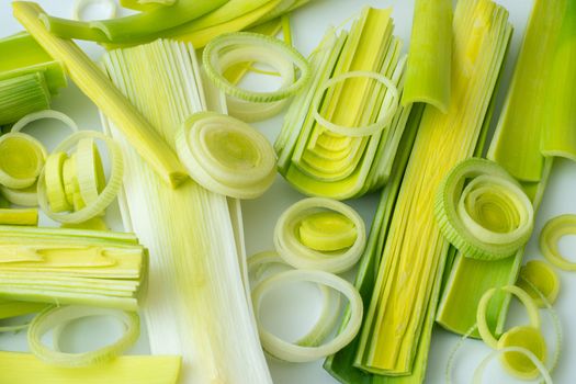 Green stems of cutted leeks isolated on white background