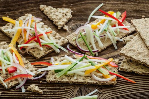 Healthy sandwiches with fresh vegetables. Breakfast toasts on wooden cutting board. Balanced breakfast.