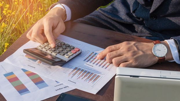 Asian businessman working with a calculators outdoor