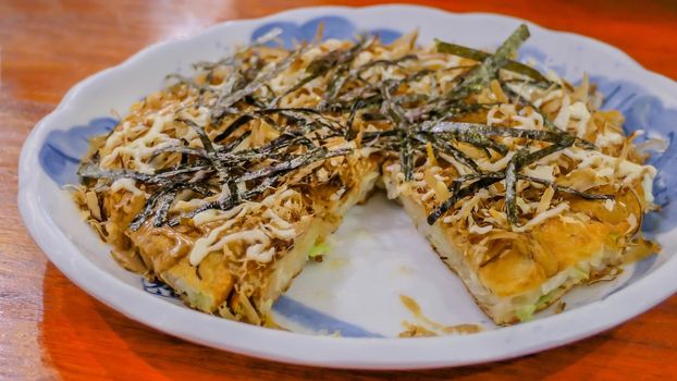 seafood Okonomiyaki pizza , Japanese-style pancakes on dish , selective focus