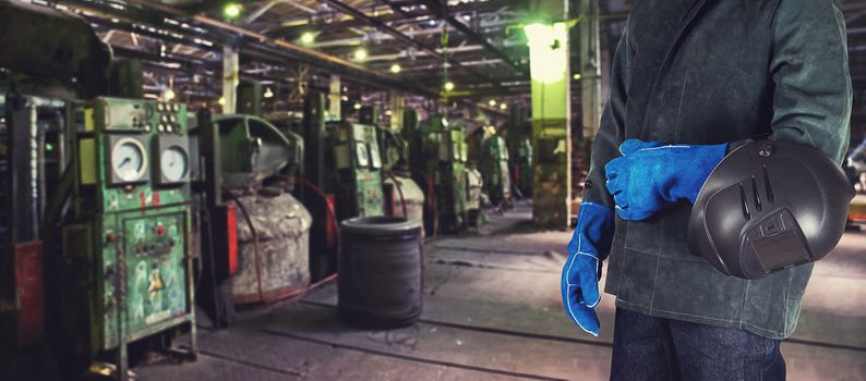 Worker welder with instruments at industrial factory