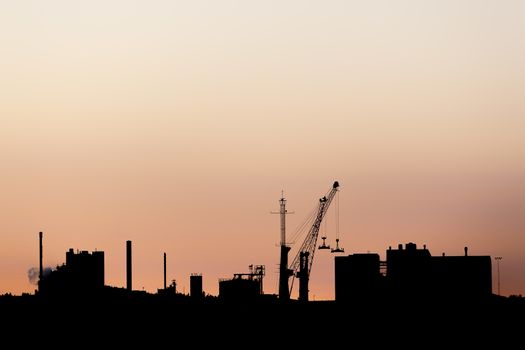 Industrial Building Silhouette at Sunset with a clear sky.