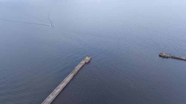 ship going in to Harbor Roja Latvia Aerial view of countryside drone top view