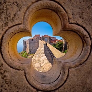 Dubrovnik city walls view through stone carved detail, Dalamtia region of Croatia