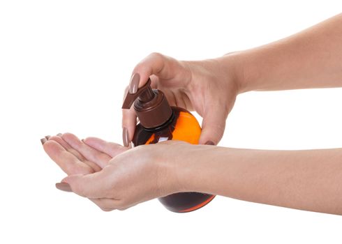 bottle with liquid soap in hand on white isolated background