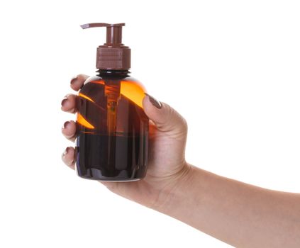 bottle with liquid soap in hand on white isolated background