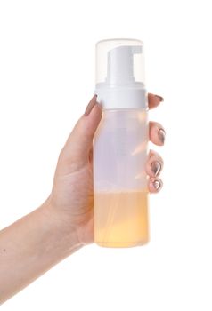 cosmetic lotion in female hand on white isolated background