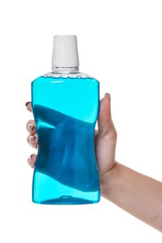 bottle with rinse aid for mouth in hand on white isolated background