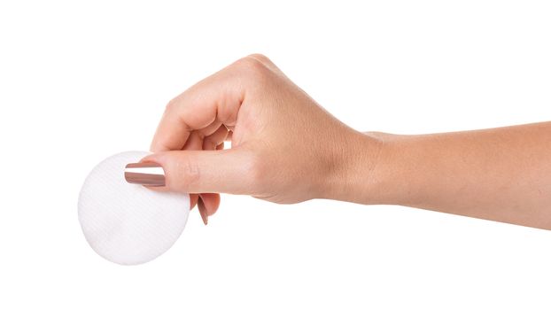 wadded disk in a female hand on white isolated background