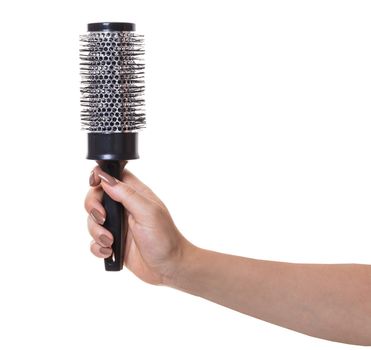 hair comb in female hand on white isolated background