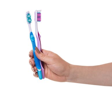 toothbrushes in a female hand on white isolated background
