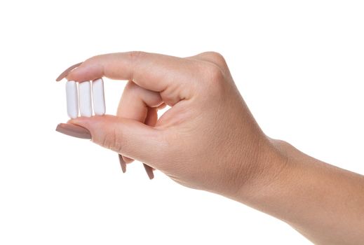 chewing gum in a female hand on white isolated background