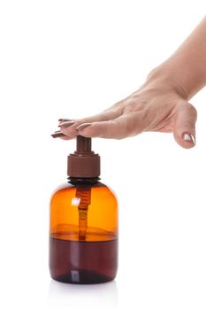 bottle with liquid soap in hand on white isolated background