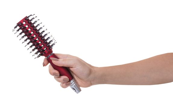 hair comb in female hand on white isolated background