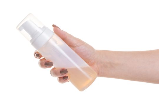 cosmetic lotion in female hand on white isolated background