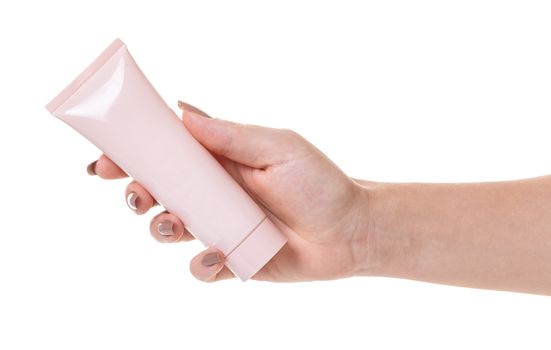 Female hand with a tube of cosmetic cream on white isolated background