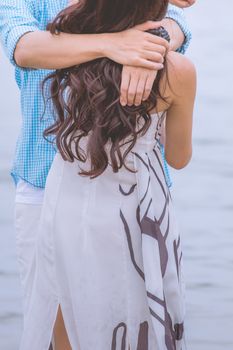 couple on romantic travel honeymoon vacation summer holidays romance. Back rear view of casual young happy lovers in full on beach.