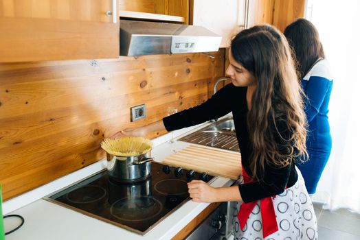 Mother and Her Lovely Daughter Cooking Some Spaghetti’s in the Kitchen for Dinner