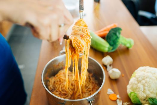 Close View of Woman Preparing a Delicious Spaghetti in The Kitchen. Healthy Food Concept.
