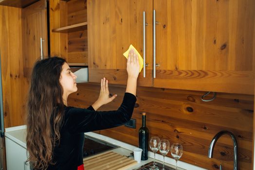 Cute Little Girl Is Cleaning The Kitchen With Yellow Rag