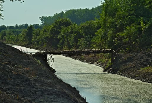 Rustic and dangerous bridge over small river