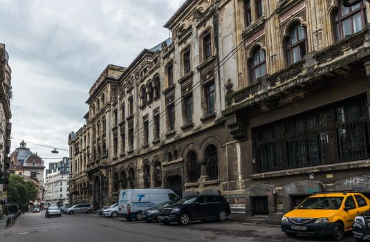 BUCHAREST, ROMANIA - 07.20.2018. Old Center of Bucharest, Romania in a cloudy summer morning. Sullen and unpleasant atmosphere, dirty streets and shabby buildings.