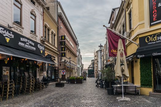 BUCHAREST, ROMANIA - 07.20.2018. Old Center of Bucharest, Romania in a cloudy summer morning. Sullen and unpleasant atmosphere, dirty streets and shabby buildings.
