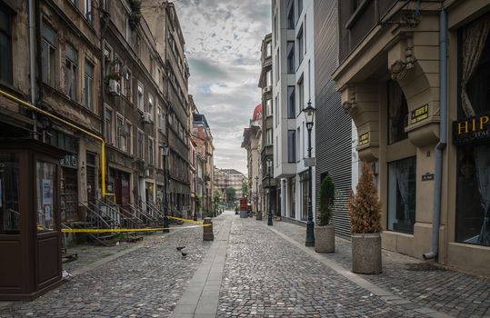 BUCHAREST, ROMANIA - 07.20.2018. Old Center of Bucharest, Romania in a cloudy summer morning. Sullen and unpleasant atmosphere, dirty streets and shabby buildings.