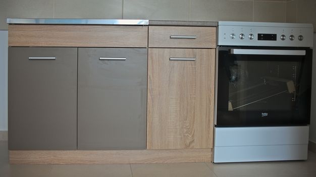 New kitchen furniture and electric stove, closeup