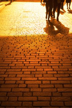 commuters walking down a cobbled lane in london city