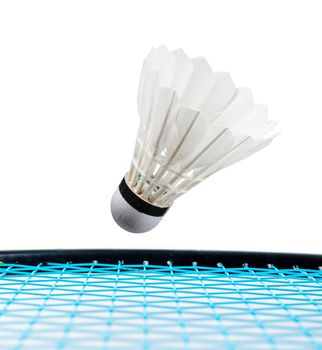 Close up shuttlecock and badminton racket on white background.