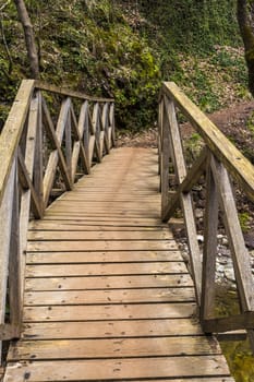 Wooden bridge on the path of Mavri Spilia (literally Black Cave), close to Proussos village, Greece