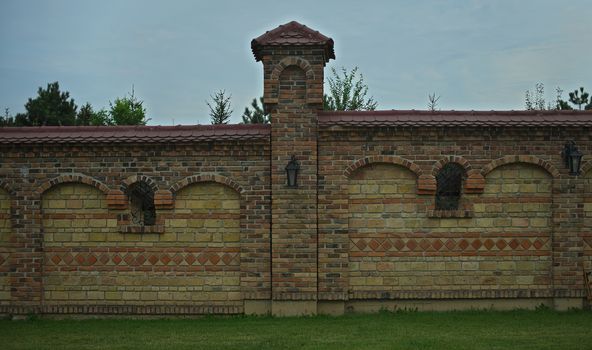 Part of fence bricks wall with pillar in the middle