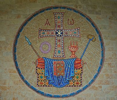 Mosaic on stone wall with christian symbols