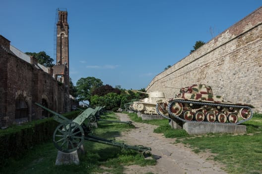 Belgrade, Serbia - April 30, 2018: Part of the outdoor exhibition of the Military Museum around Sahat kula, the clock tower and gate of the Belgrade Kalemegdan fortress or Beogradska Tvrdjava, Serbia